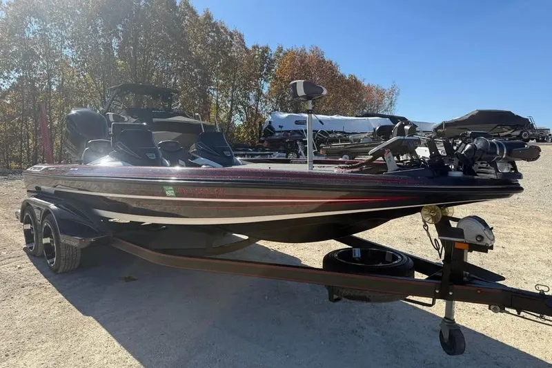 Slide: The Image of 2018 Skeeter FX21 Limited Edition boat on trailer, parked outdoors under clear sky. - 3