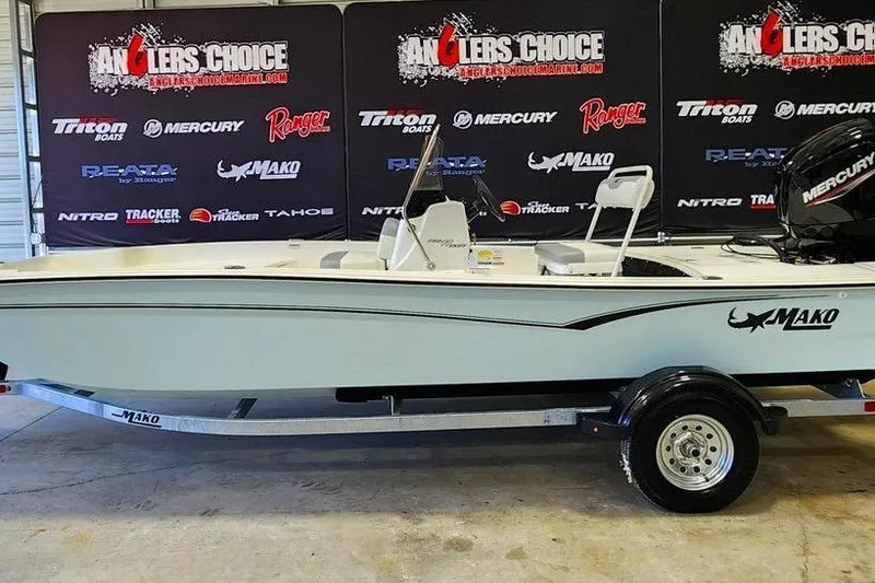 The Image of 2026 Mako Pro Skiff 17 CC boat on trailer, displayed at Anglers Choice event. - 1