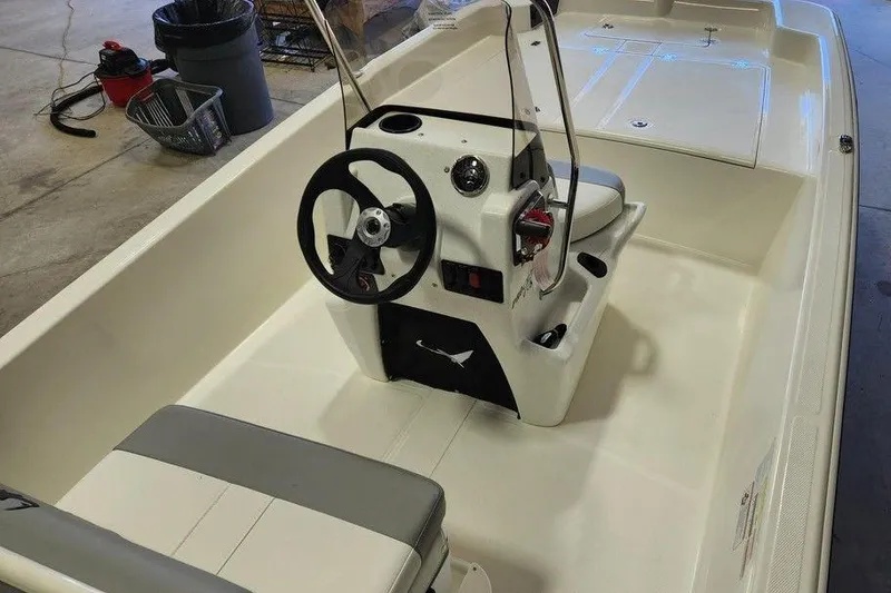 Slide: The Image of 2026 Mako Pro Skiff 17 CC interior with steering console and seating. - 4