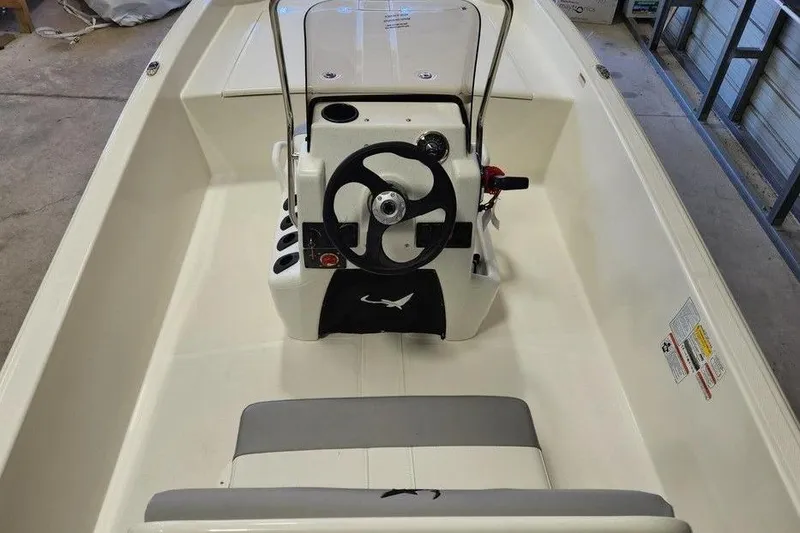 Slide: The Image of 2026 Mako Pro Skiff 17 CC boat interior with steering console and seating. - 9