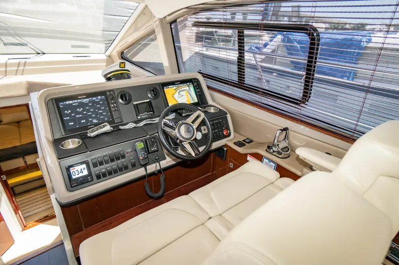 Slide: The Image of 2017 Sea Ray Sundancer 460 helm with modern navigation controls and luxurious seating. - 10