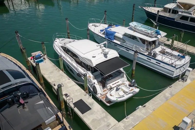 Slide: The Image of 2017 Sea Ray Sundancer 460 yacht docked at marina, surrounded by other boats. - 104