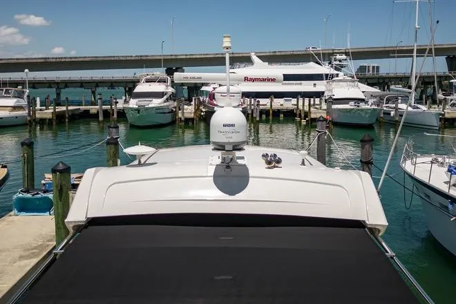 Slide: The Image of 2017 Sea Ray Sundancer 460 yacht docked at marina with other boats. - 105