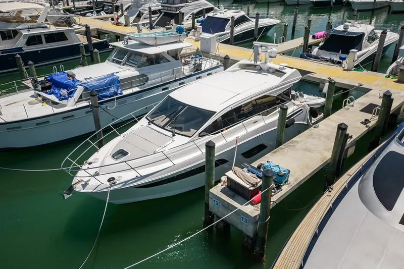 Slide: The Image of 2017 Sea Ray Sundancer 460 yacht docked at marina, surrounded by other boats. - 108
