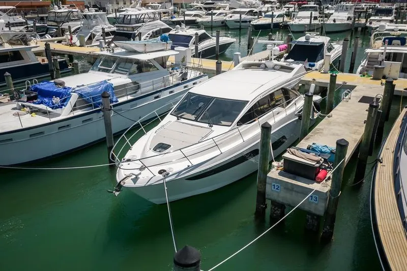Slide: The Image of 2017 Sea Ray Sundancer 460 yacht docked in a busy marina. - 109