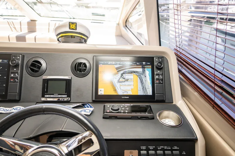 Slide: The Image of 2017 Sea Ray Sundancer 460 helm with navigation display and captain's hat. - 15