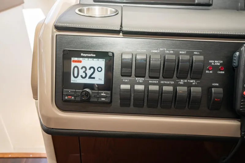 Slide: The Image of Control panel of 2017 Sea Ray Sundancer 460 with Raymarine display and switches. - 16