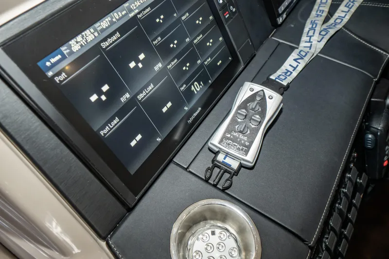 Slide: The Image of 2017 Sea Ray Sundancer 460 dashboard with control panel and remote. - 18