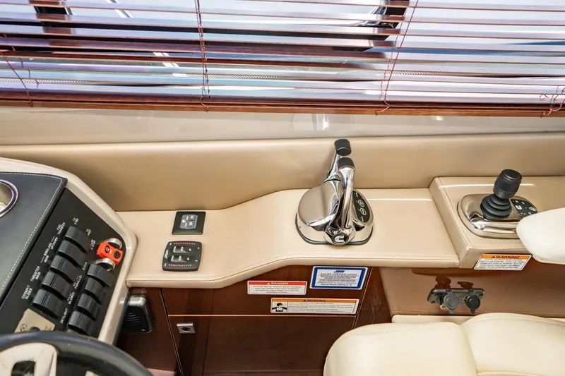 Slide: The Image of 2017 Sea Ray Sundancer 460 helm controls with joystick and throttle levers. - 19