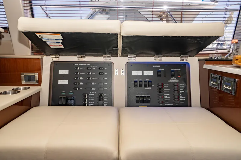 Slide: The Image of 2017 Sea Ray Sundancer 460 yacht interior with open electrical control panel. - 21