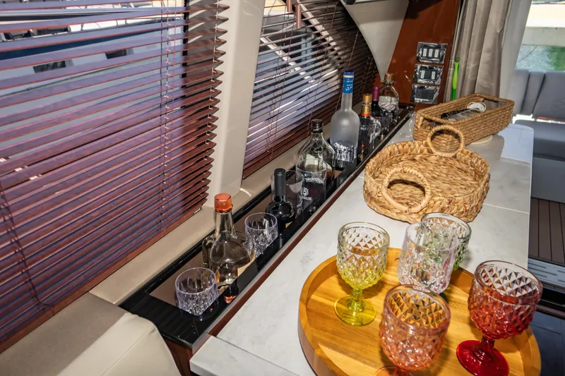 Slide: The Image of Luxurious interior of 2017 Sea Ray Sundancer 460 yacht with bar setup and colorful glassware. - 26