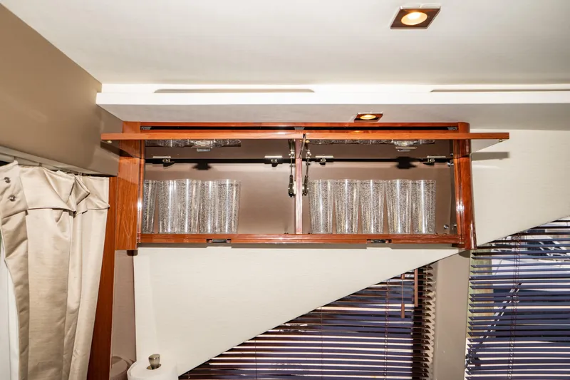 Slide: The Image of Cabinet with glassware inside a 2017 Sea Ray Sundancer 460 yacht interior. - 27