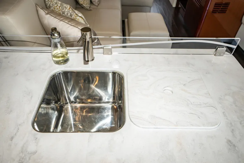 Slide: The Image of Modern kitchen sink area on 2017 Sea Ray Sundancer 460 yacht with marble countertop. - 35