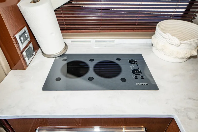 Slide: The Image of Kenyon cooktop in 2017 Sea Ray Sundancer 460 yacht kitchen, with paper towel and basket. - 36