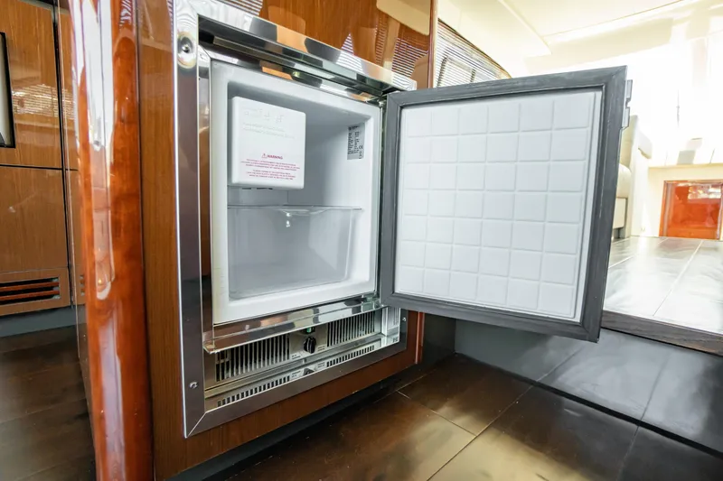 Slide: The Image of Open refrigerator inside 2017 Sea Ray Sundancer 460 yacht, showcasing modern interior design. - 37