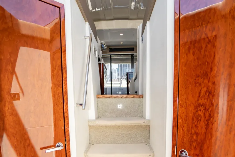 Slide: The Image of Interior view of 2017 Sea Ray Sundancer 460 yacht with polished wood doors and carpeted stairs. - 42