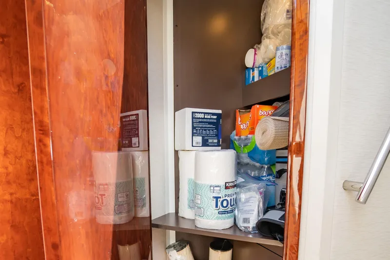Slide: The Image of Storage cabinet on 2017 Sea Ray Sundancer 460 yacht, stocked with household supplies. - 43