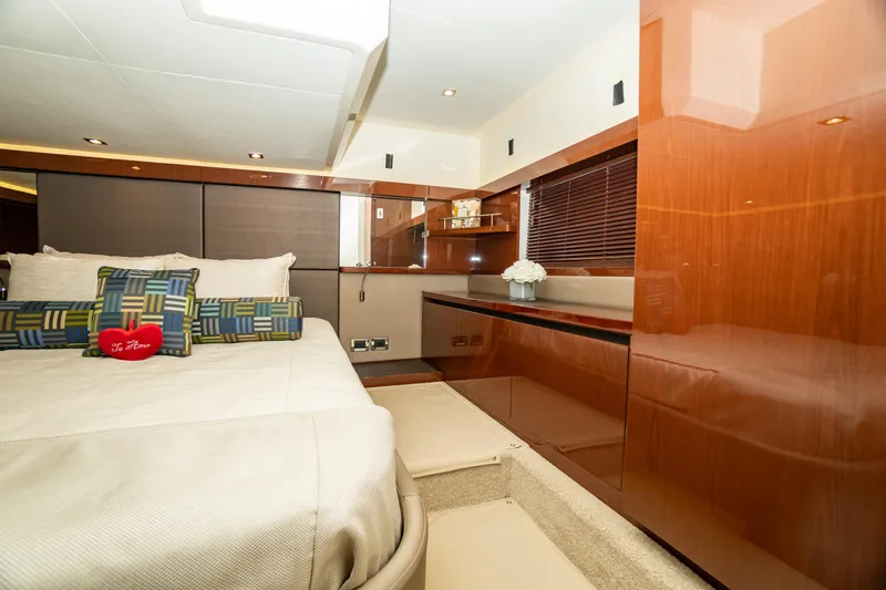 Slide: The Image of Luxurious 2017 Sea Ray Sundancer 460 yacht cabin with elegant wood finishes and plush bedding. - 48