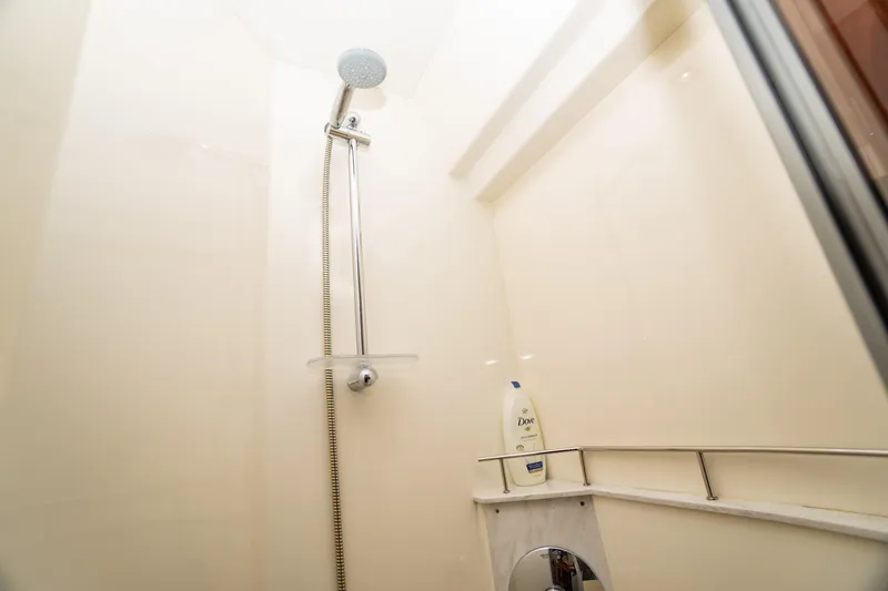 Slide: The Image of Shower area in 2017 Sea Ray Sundancer 460 yacht, featuring modern fixtures and Dove shampoo. - 60