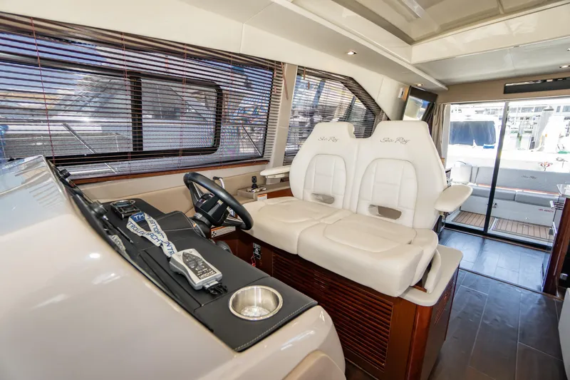 Slide: The Image of 2017 Sea Ray Sundancer 460 helm with plush seating and modern controls. - 7