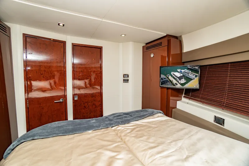 Slide: The Image of Luxurious 2017 Sea Ray Sundancer 460 yacht bedroom with TV and elegant wood finishes. - 70