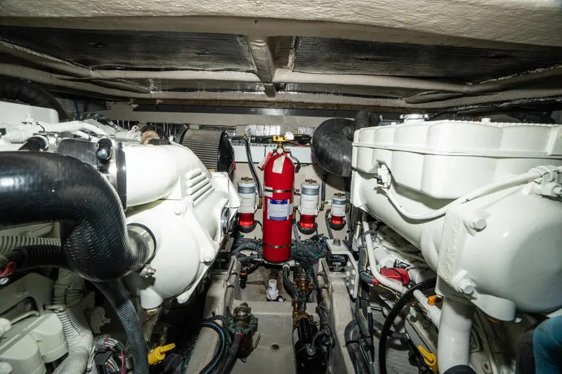 Slide: The Image of Engine room of 2017 Sea Ray Sundancer 460 with fire extinguisher and mechanical components. - 71