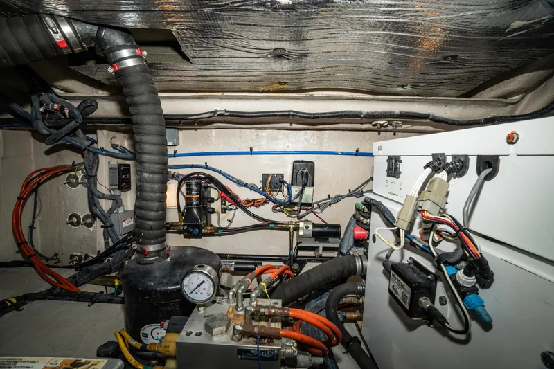 Slide: The Image of Engine room of 2017 Sea Ray Sundancer 460 with complex wiring and mechanical components. - 72