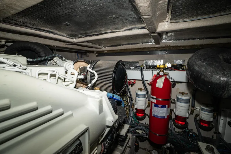 Slide: The Image of Engine room of 2017 Sea Ray Sundancer 460 with fire extinguisher and filters. - 79
