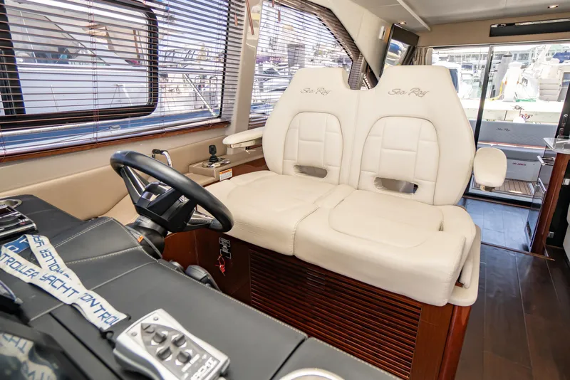 Slide: The Image of Interior of 2017 Sea Ray Sundancer 460 yacht with plush seating and modern controls. - 8