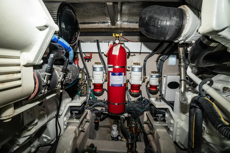 Slide: The Image of Engine room of 2017 Sea Ray Sundancer 460 with fire extinguisher and mechanical components. - 80