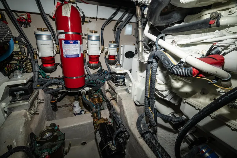 Slide: The Image of Engine room of 2017 Sea Ray Sundancer 460 with fire extinguisher and mechanical components. - 81