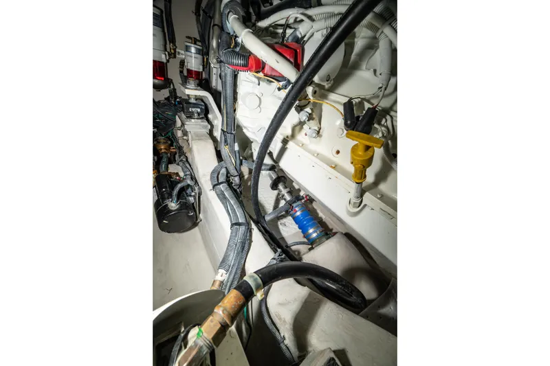 Slide: The Image of Engine compartment of 2017 Sea Ray Sundancer 460 with visible wiring and components. - 83