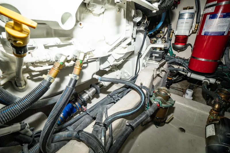 Slide: The Image of Engine room of 2017 Sea Ray Sundancer 460 with visible hoses and components. - 88