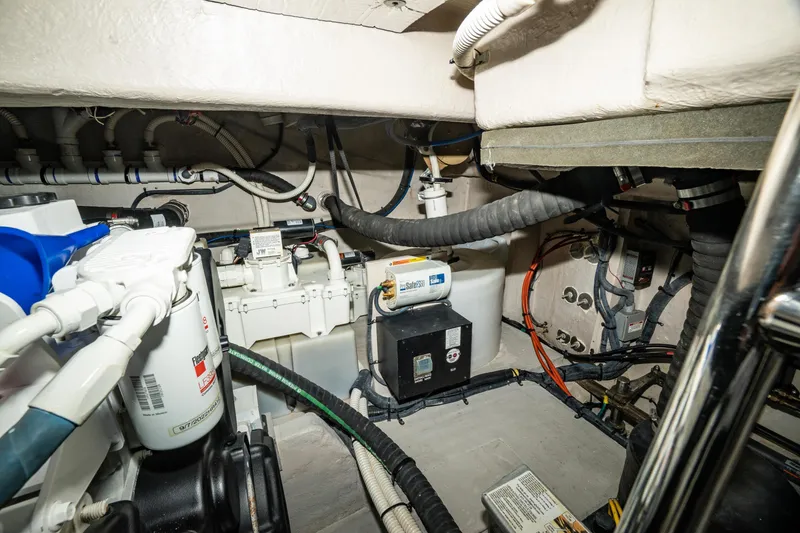 Slide: The Image of Engine room of 2017 Sea Ray Sundancer 460 with various mechanical components and wiring. - 89