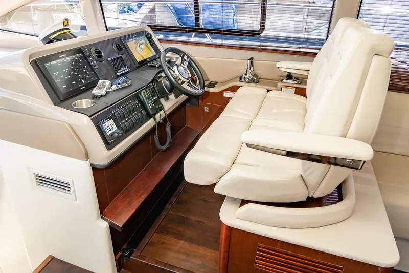 Slide: The Image of Luxurious helm of 2017 Sea Ray Sundancer 460 with leather seating and advanced controls. - 9