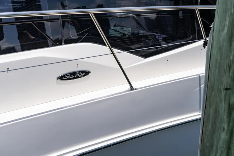 Slide: The Image of 2017 Sea Ray Sundancer 460 yacht, sleek white exterior with railing and logo. - 98