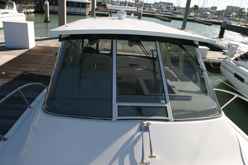 Slide: The Image of 1996 Hatteras 39 Sport Express boat docked at marina, front view. - 13
