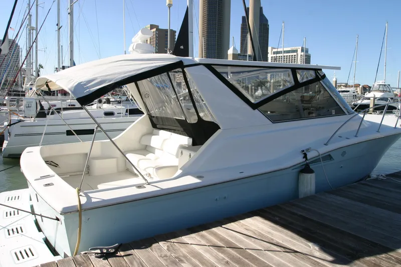 Slide: The Image of 1996 Hatteras 39 Sport Express yacht docked at a marina. - 16