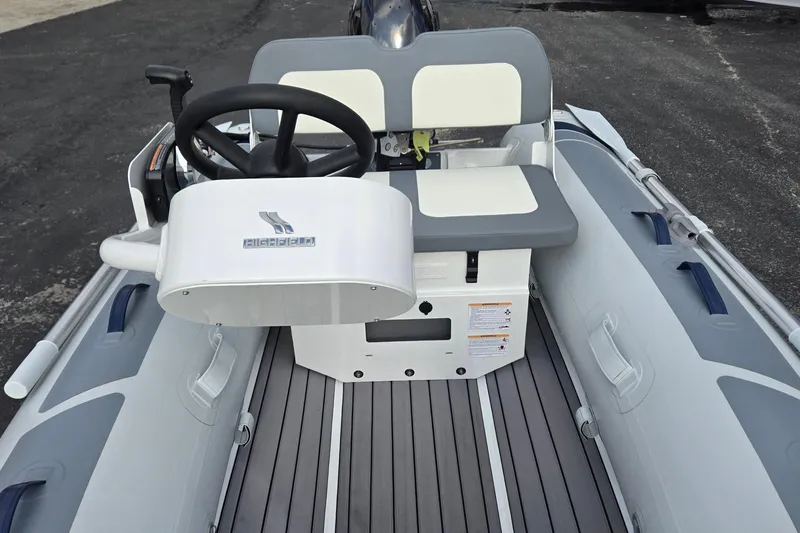 Slide: The Image of 2025 Highfield Classic 310 boat interior with steering wheel and seating. - 10