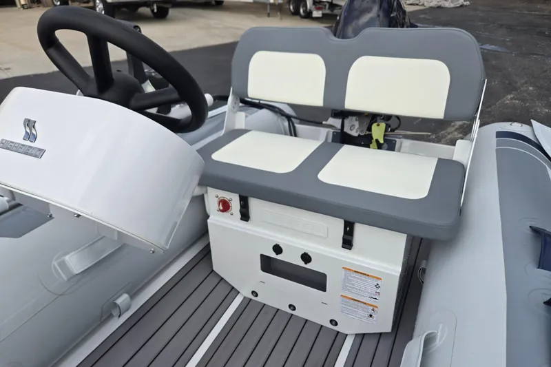 Slide: The Image of 2025 Highfield Classic 310 boat interior with steering wheel and cushioned seating. - 12