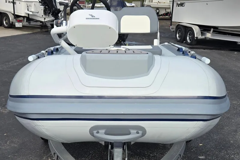 Slide: The Image of 2025 Highfield Classic 310 inflatable boat on trailer, parked outdoors. - 8