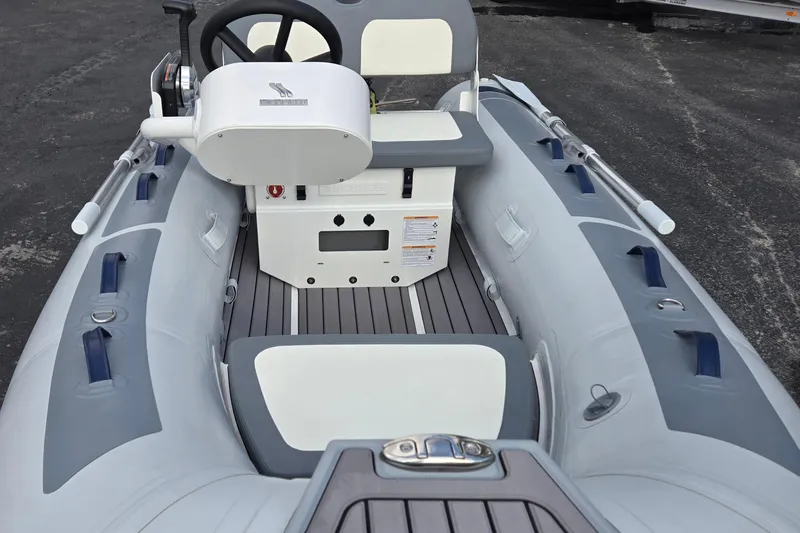 Slide: The Image of 2025 Highfield Classic 310 inflatable boat interior with steering console and seating. - 9