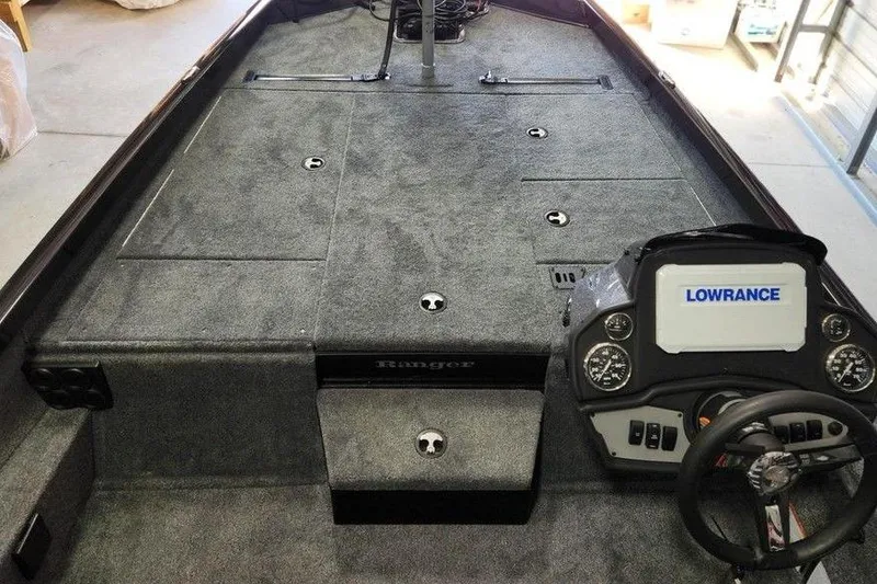 Slide: The Image of 2026 Ranger RT188P boat interior with Lowrance electronics and carpeted deck. - 5