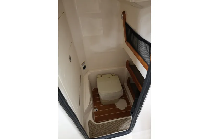 Slide: The Image of 2026 Grady-White Fisherman 257 boat interior with compact marine toilet. - 10