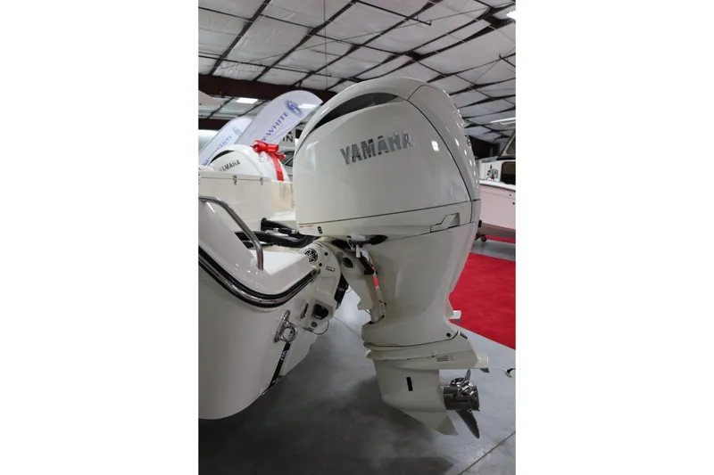 Slide: The Image of 2026 Grady-White Fisherman 257 with Yamaha outboard motor in showroom. - 13