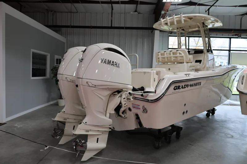 Slide: The Image of 2026 Grady-White Fisherman 257 boat with dual Yamaha engines in a showroom. - 14