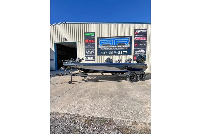 The Image of 2023 Nitro Z20 Pro boat parked outside a marine products shop. - 1