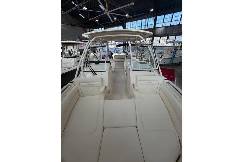 Slide: The Image of 2026 Grady-White Freedom 285 boat interior with spacious seating in a showroom. - 13