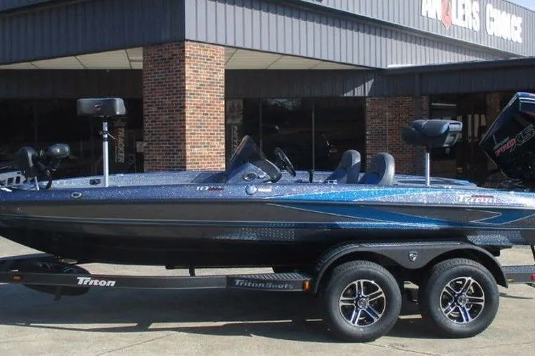 The Image of 2026 Triton 18 TrX boat on trailer outside a building. - 1