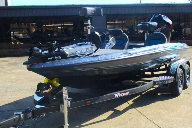 Slide: The Image of 2026 Triton 18 TrX boat on trailer, parked outdoors, featuring sleek design and modern equipment. - 5